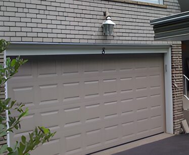 A garage door that is open and has a light on it.