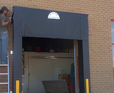 A door to an industrial building with a large window.