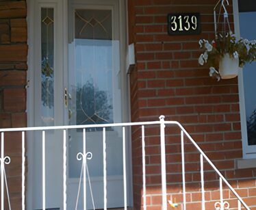 A house with a white railing and door.