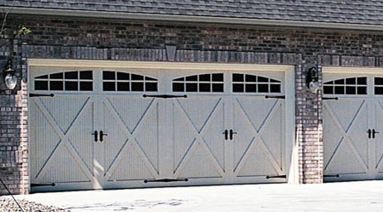 A white garage door with black hardware and windows.