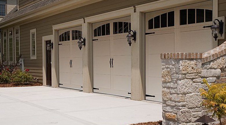 A row of garage doors in front of a building.