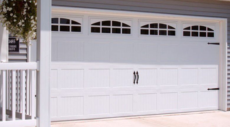 A white garage door with three windows on the side.